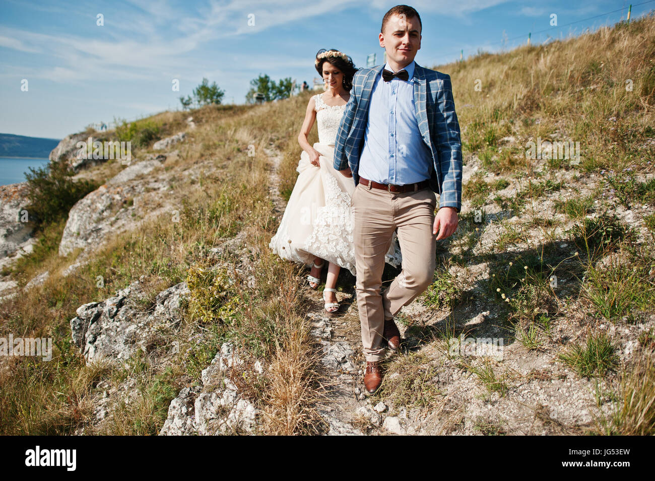 Beautiful wedding couple walking and enjoying each other's company in a ...