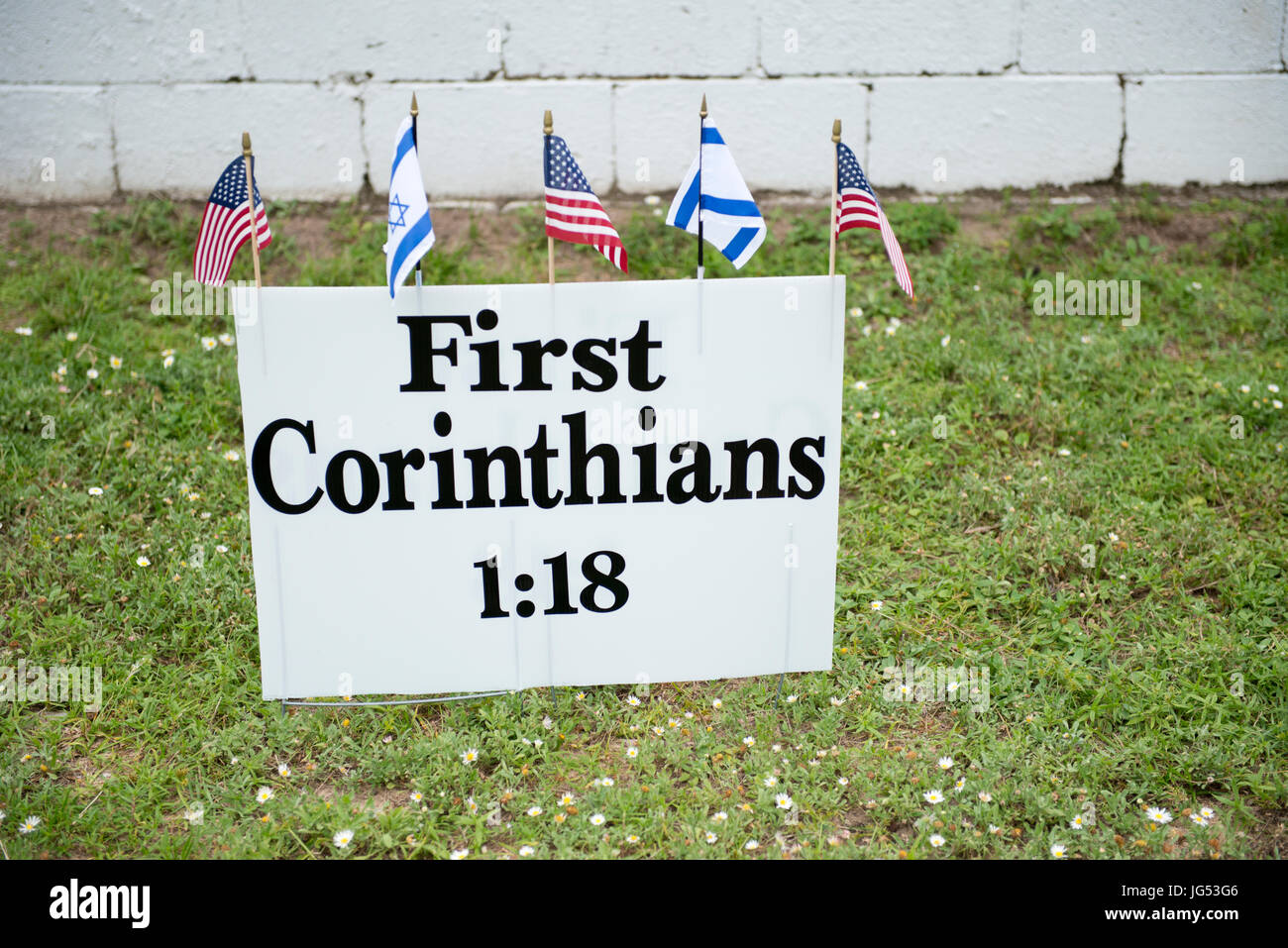Pensacola, Florida, USA. 27th June, 2017. Bible verse displayed on sign with American and Jewish flag nearby the Save the Bayview Cross Rally.   Sandy Stock Photo