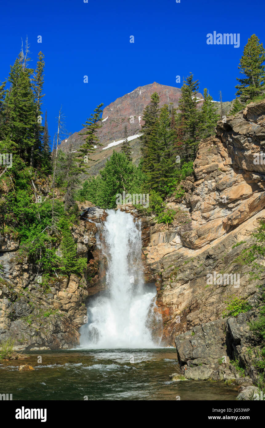 running eagle (trick) falls below rising wolf mountain in glacier national park, montana Stock Photo