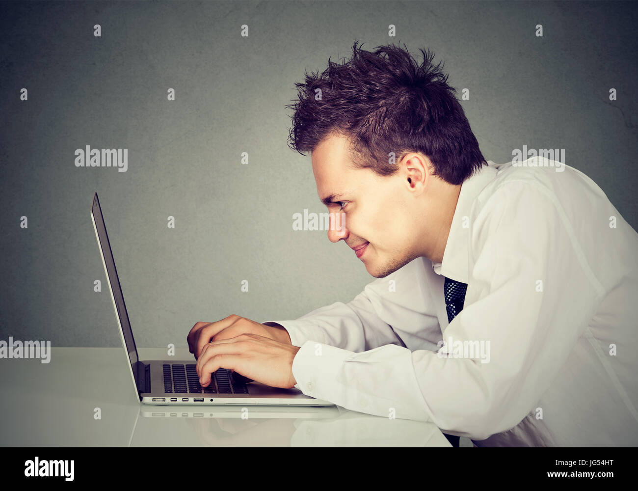 Happy man working on laptop computer Stock Photo