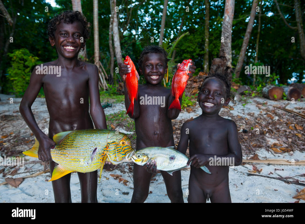 Boys proudly showing their fish they catched in the Marovo Lagoon, Salomon Islands, Pacific Stock Photo