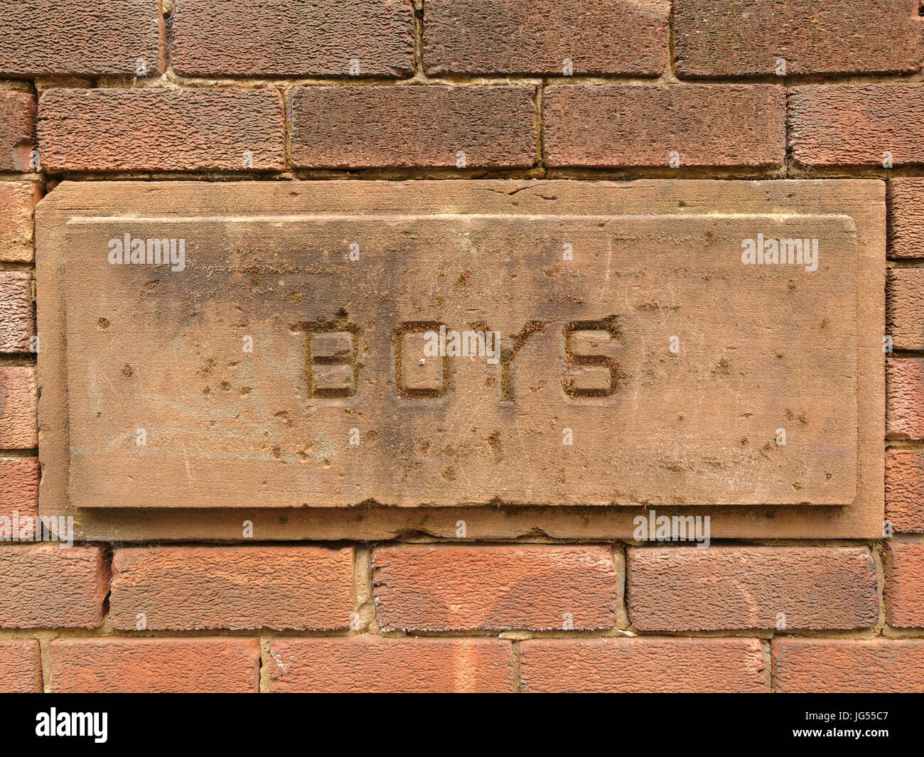 stone school building vintage sculpted sign boys Stock Photo