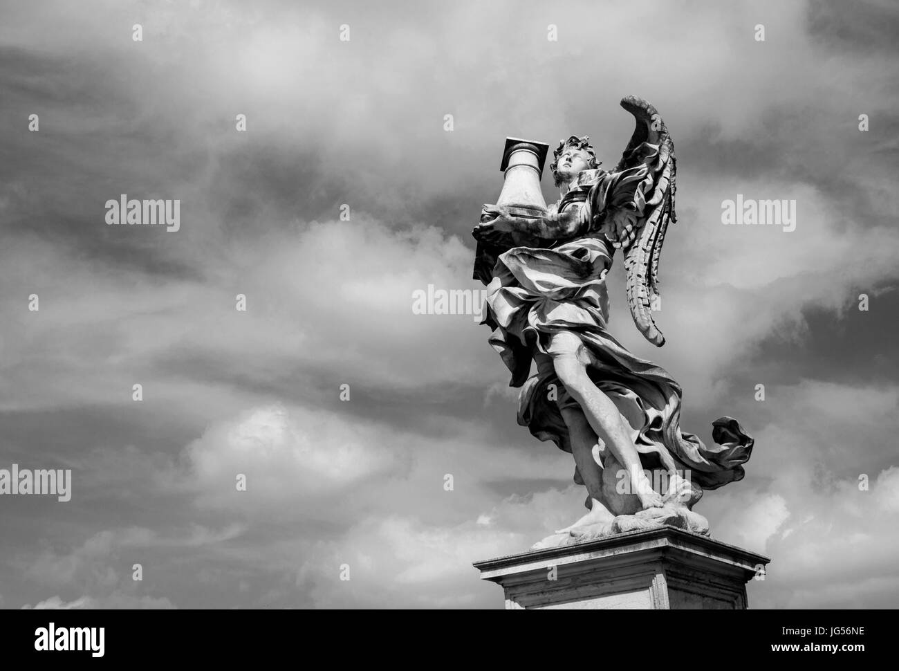 Angel statue holding the Holy Column looks at the heavenly sky on Sant'Angelo Bridge in the center of Rome (Black and White) Stock Photo