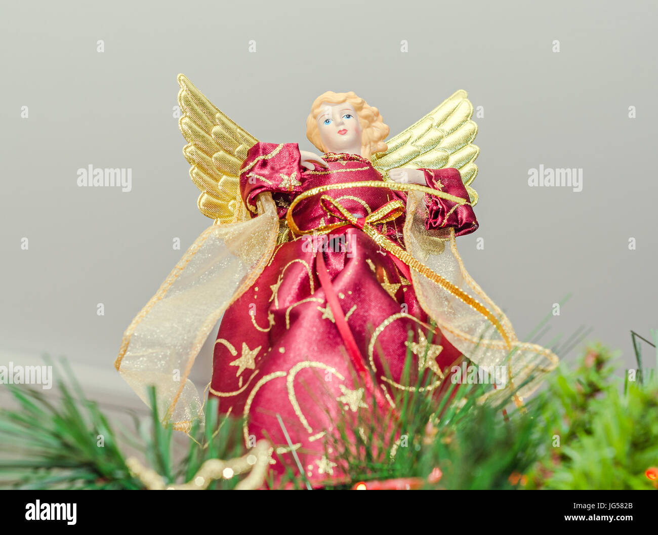 Angel Christmas tree ornament, topper, close up. Dressed angel with