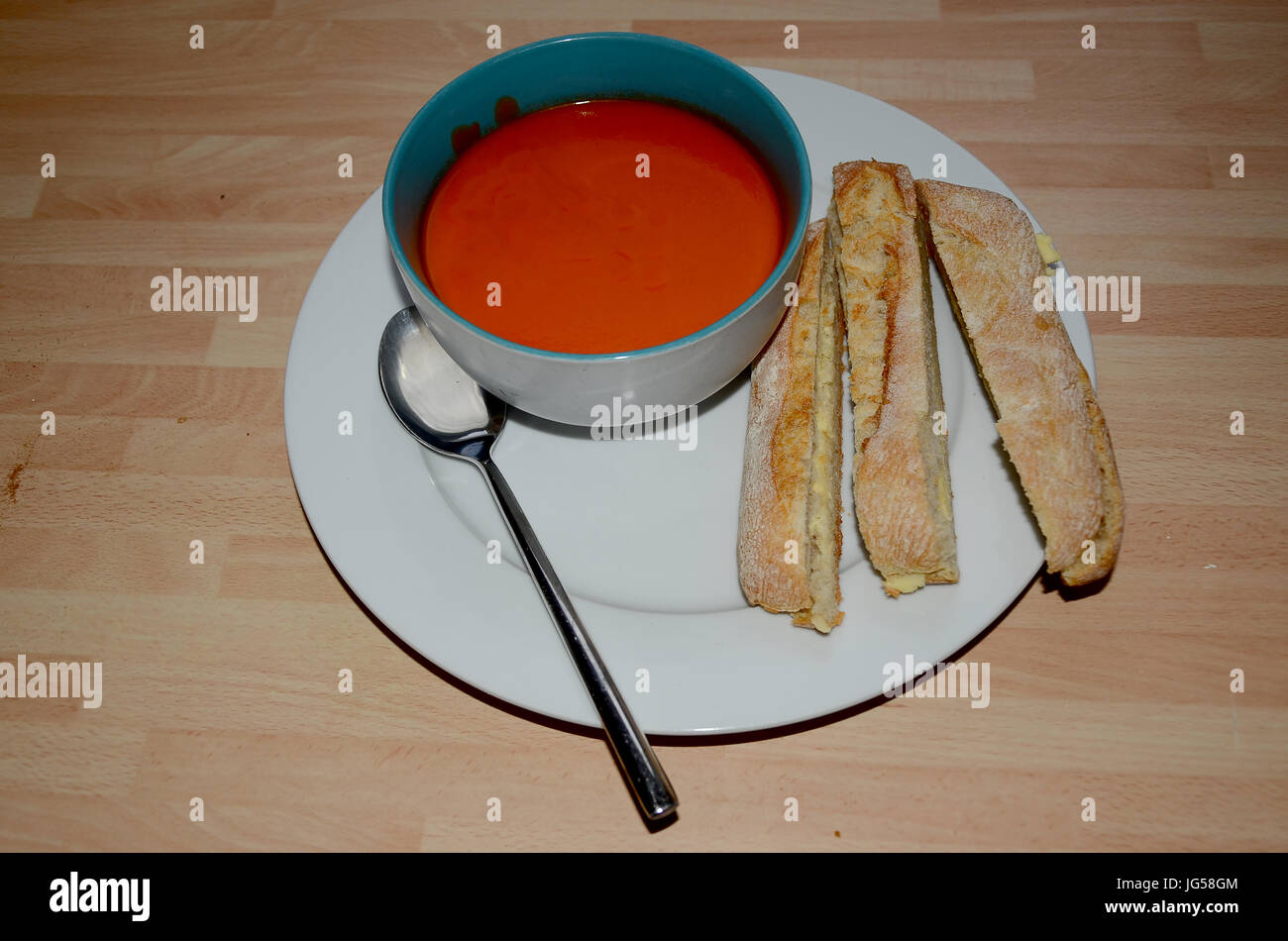 tomato soup with rustic bread sticks Stock Photo Alamy