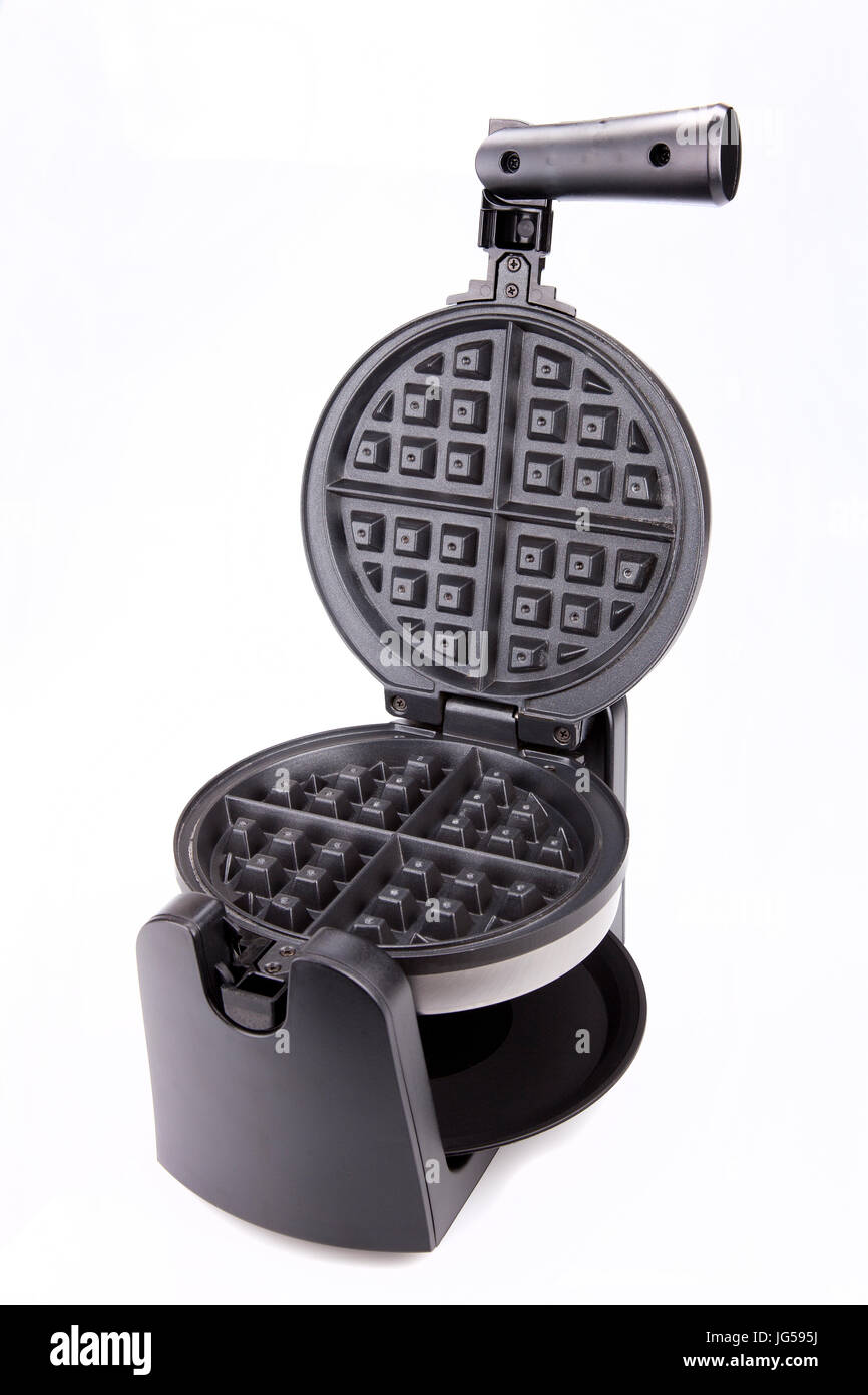 Heart Shaped Waffle Maker In Use On A Wood Countertop Stock Photo