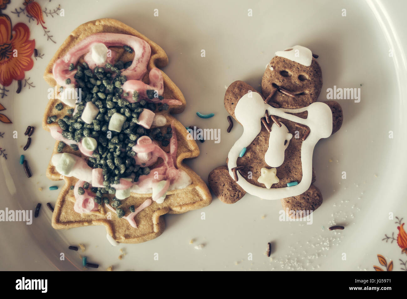 High angle view of Christmas cookies on a plate, a gingerbread man and a Christmas tree. Stock Photo