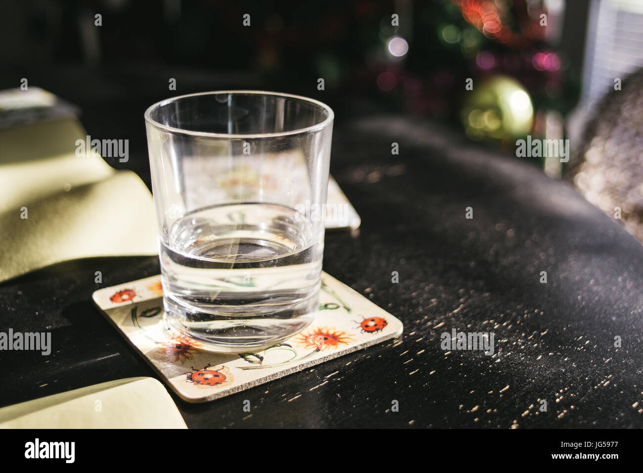 Glass of water standing on a black table. Stock Photo