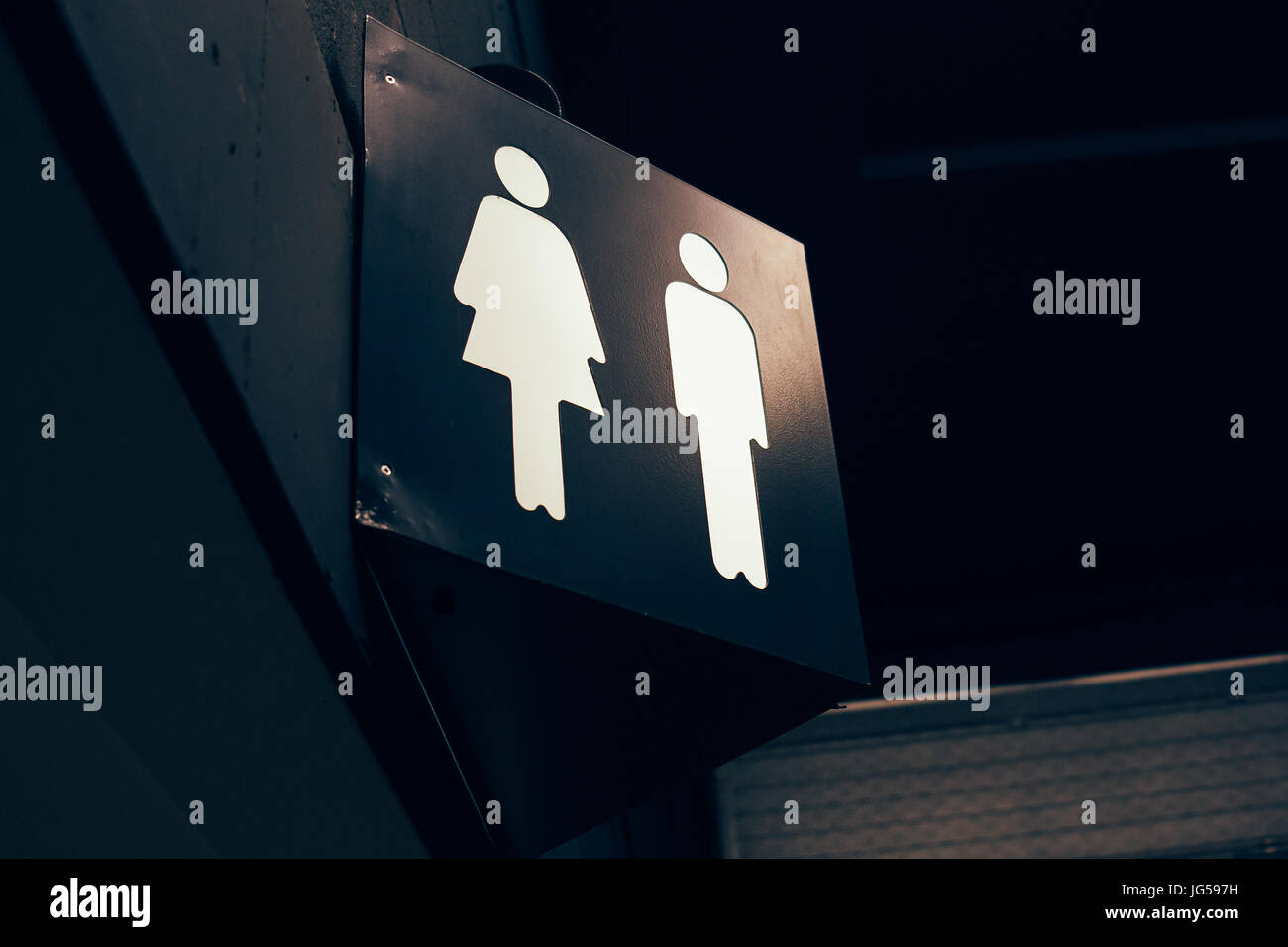 Toilet sign in a dark indoor room. Stock Photo