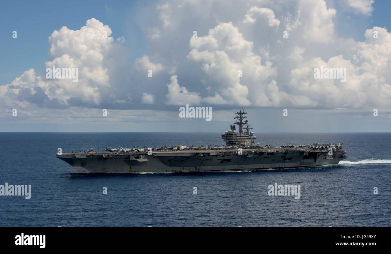 The U.S. Navy Nimitz-class aircraft carrier USS Ronald Reagan steams underway June 26, 2017 in the Pacific Ocean.    (photo by MCS2 Nathan Burke  via Planetpix) Stock Photo