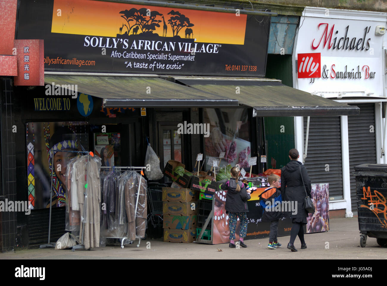 ethnic shop African Great Western Road Glasgow Scotland UK white family pedestrians on street Stock Photo