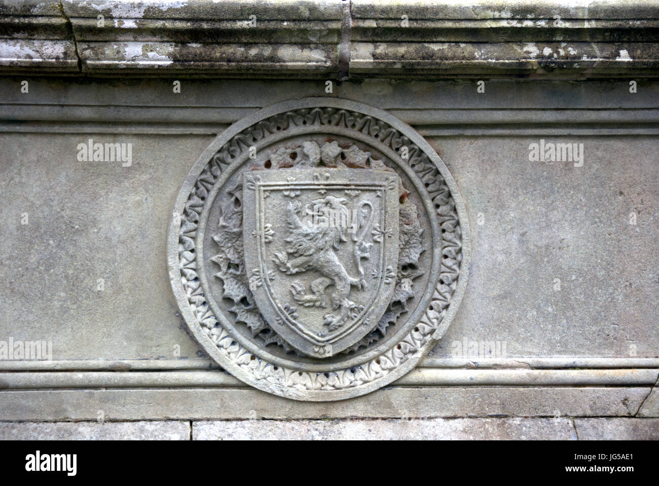 lion rampant on a shield royal symbol of Scotland embossed sculpted in grey stone from the side of the fountain in kelvingrove park Stock Photo