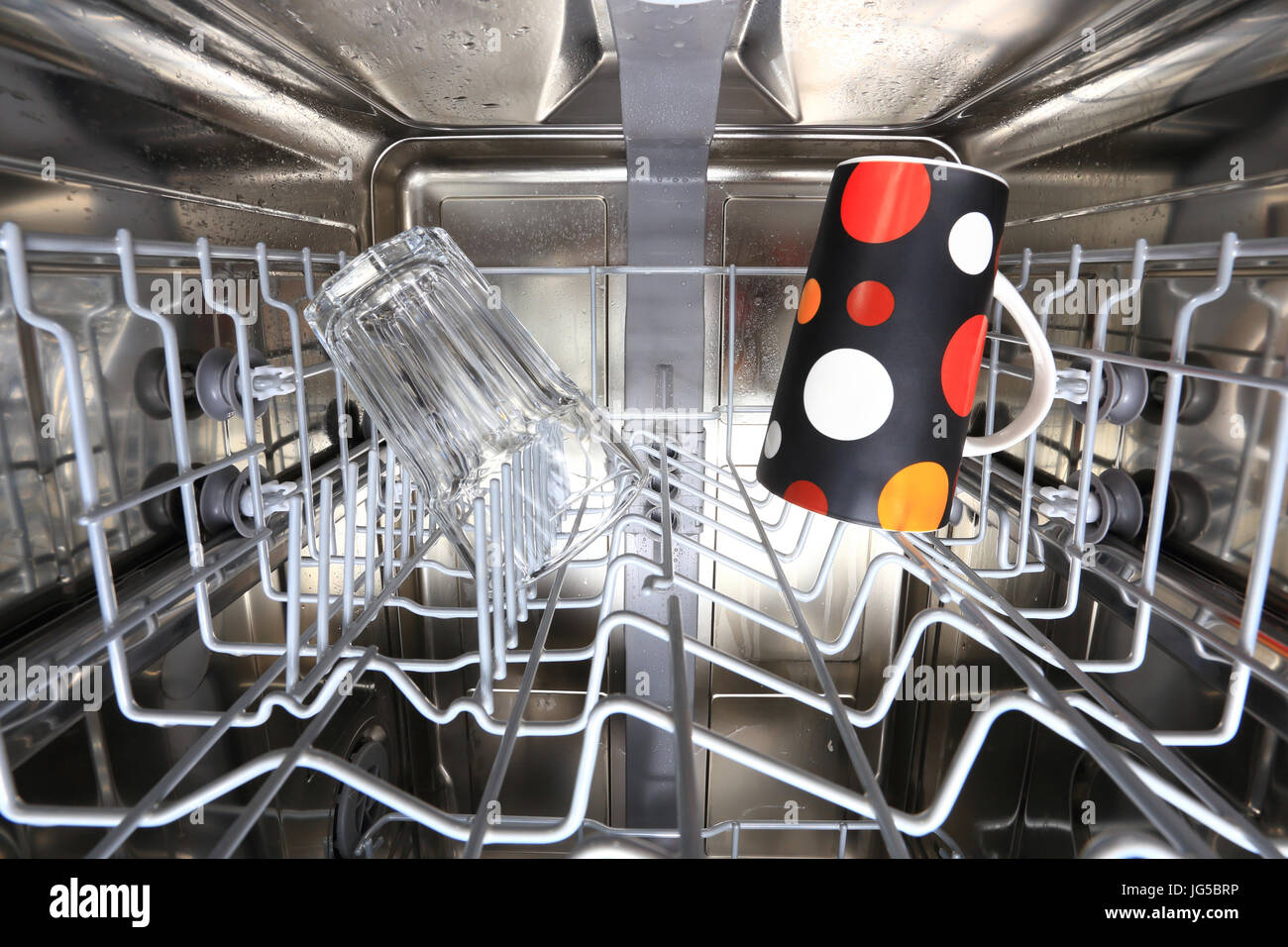 Dishwasher with clean cups inside closeup. Inside of dishwaher machine