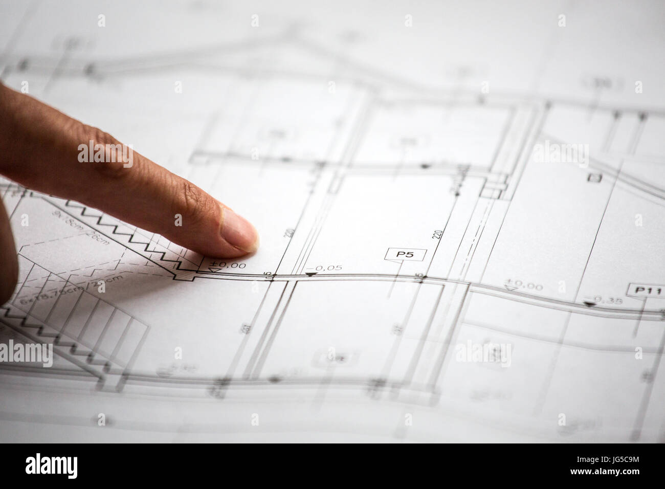 Pointing to specific place on architectural sketches of new house Stock Photo