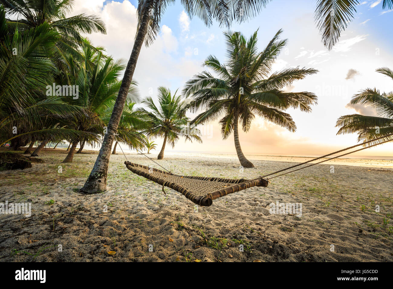 Hammock between palms on sandy beach, Diani, Kenya Stock Photo