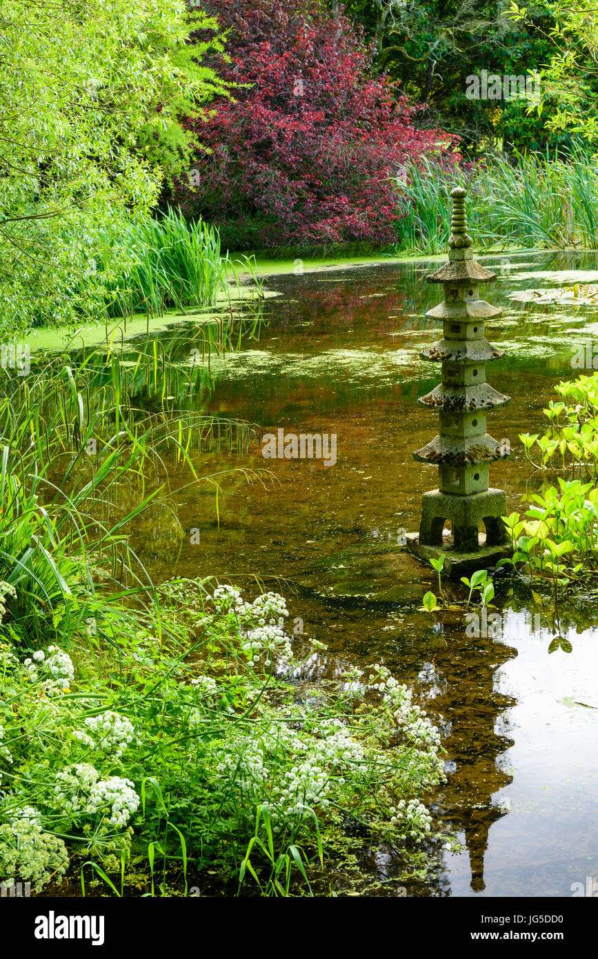 A Japanese Pergoda style water ornament in a formal pond Stock Photo