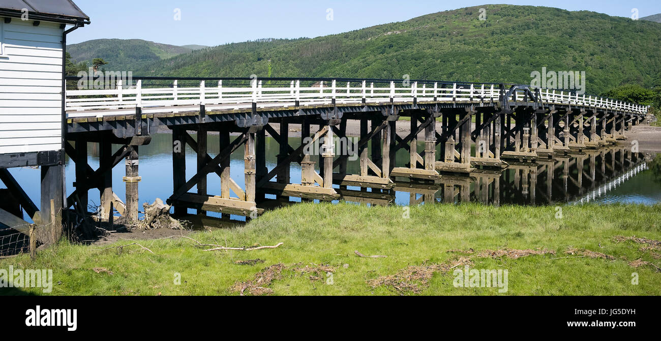The rickety 19th century toll bridge across the Mawddach Estuary at Penmaenpool, Dolgellau, Gwynedd, Wales, UK Stock Photo