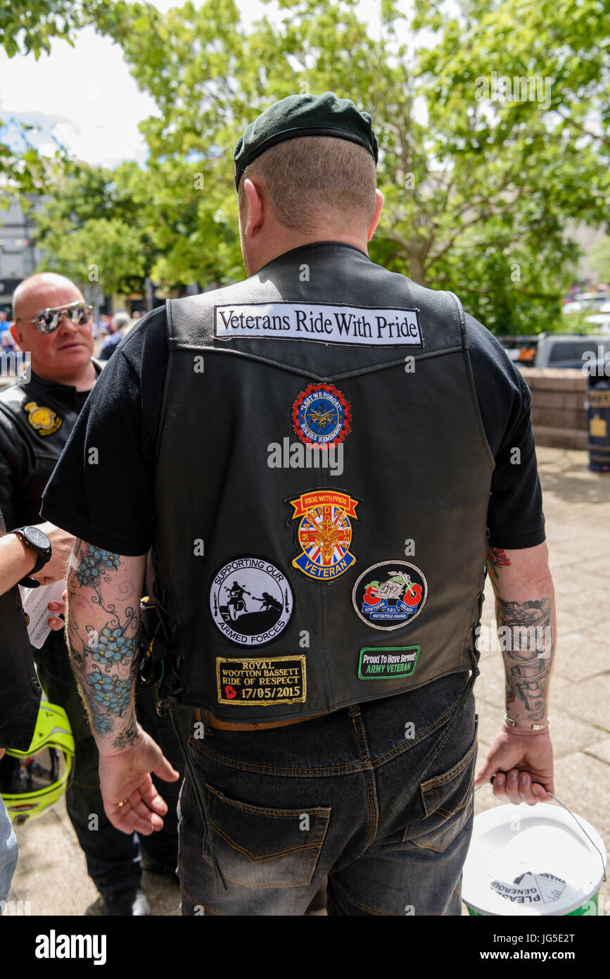 Army veteran wearing a motorbike leather jacket with patches on the back 'Veterans Ride with Pride', 'Lest we Forget, Bikers Remember', 'Armed Forces  Stock Photo