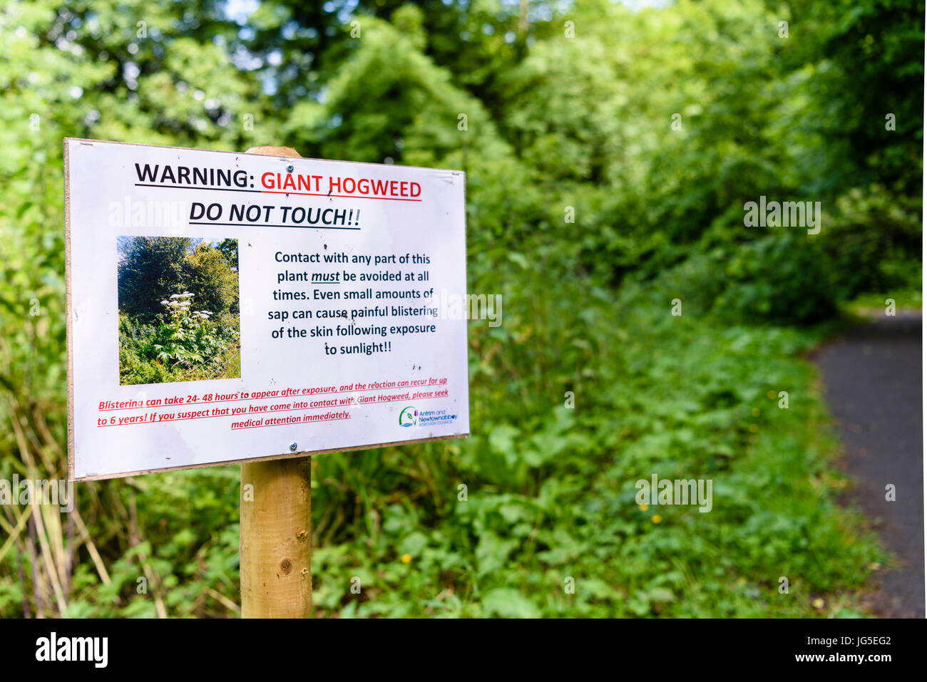 Sign warning visitors to avoid giant hogweed.  Contact with any part of this plant must be avoided at all times.  Even small amoutns of sap can cause  Stock Photo
