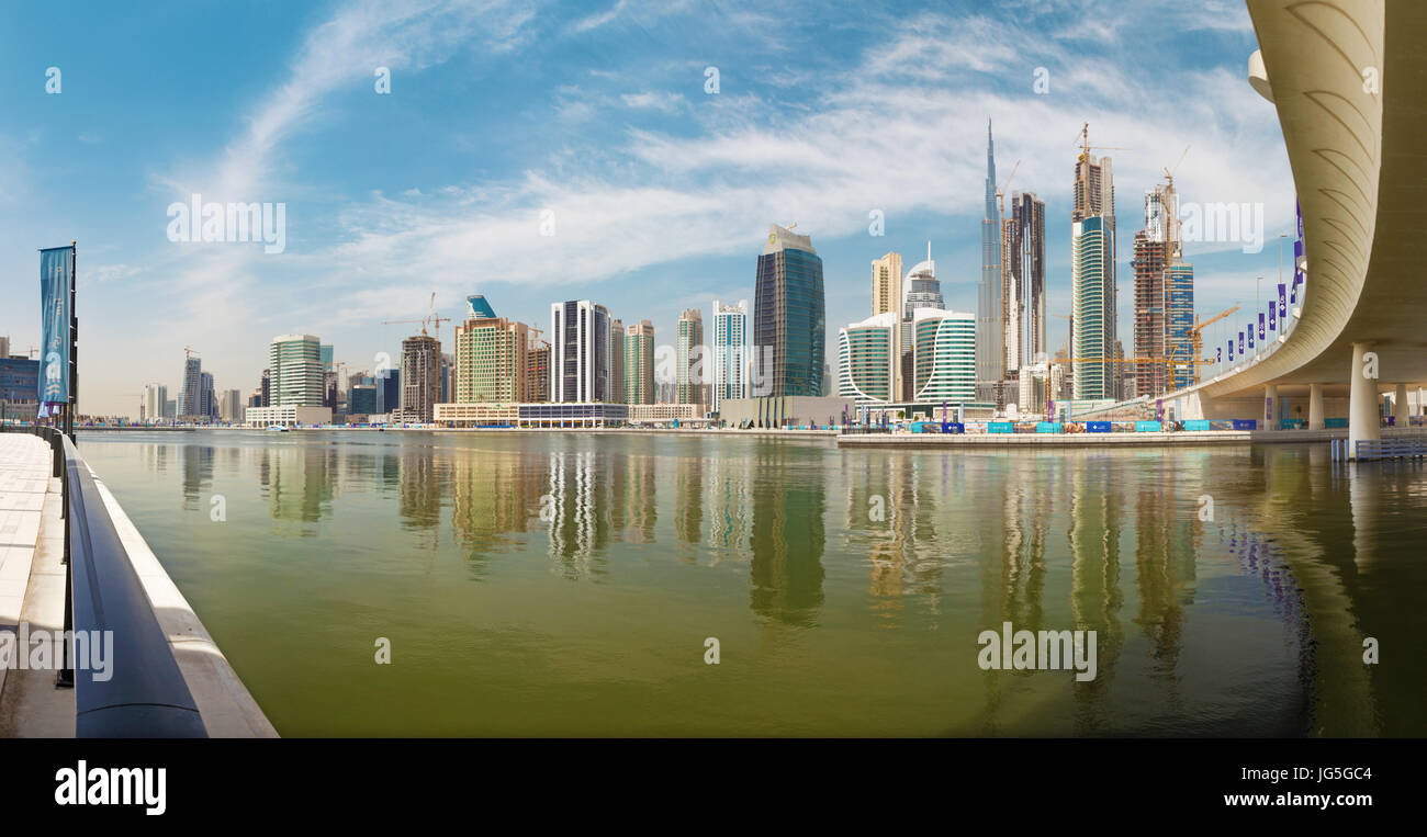 DUBAI, UAE - MARCH 29, 2017: The skyline with the bridge over the new Canal and Downtown and Burj Khalifa tower. Stock Photo