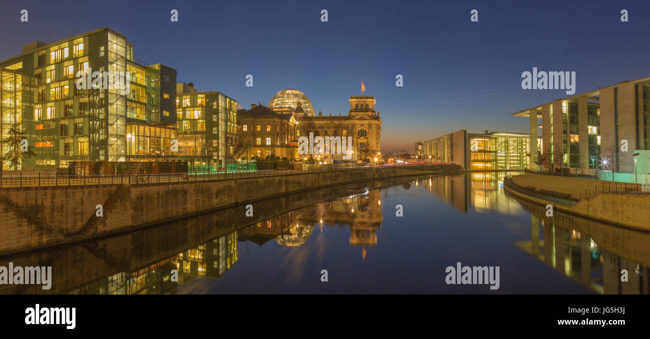 BERLIN, GERMANY, FEBRUARY - 16, 2017: Panorama of modern Government buildings and Reichstag over the Spree river in evening dusk. Stock Photo