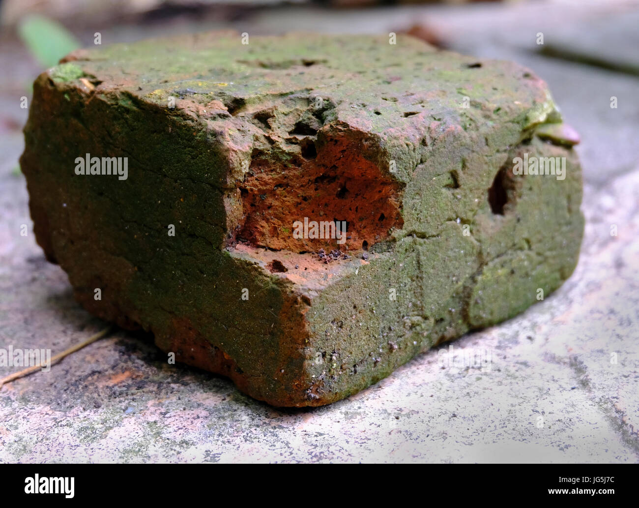 Half brick crumbling and weatherbeaten Stock Photo