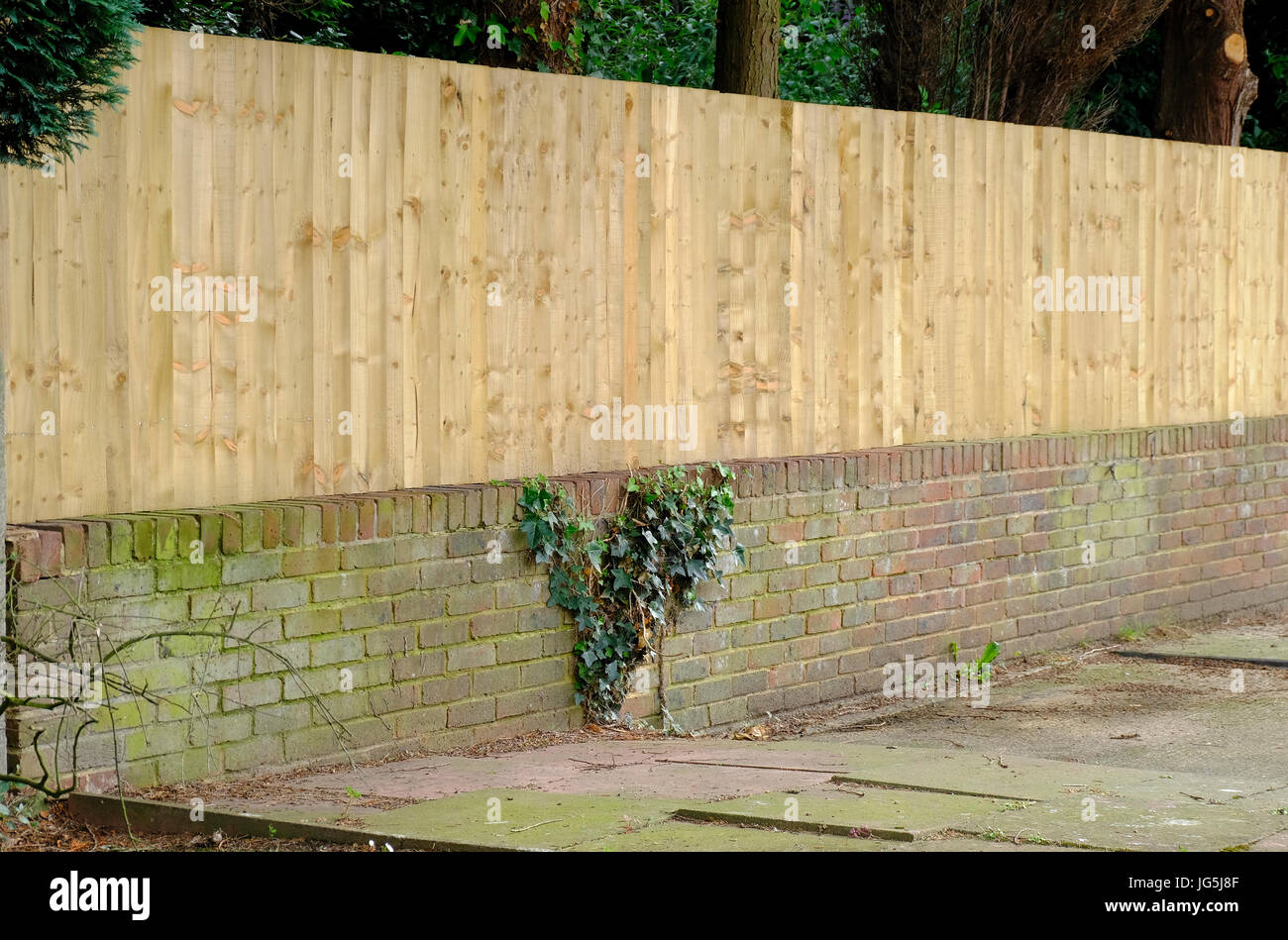 New Wooden Fence Built On Top Of Low Brick Wall - Sussex, United Kingdom  Stock Photo - Alamy