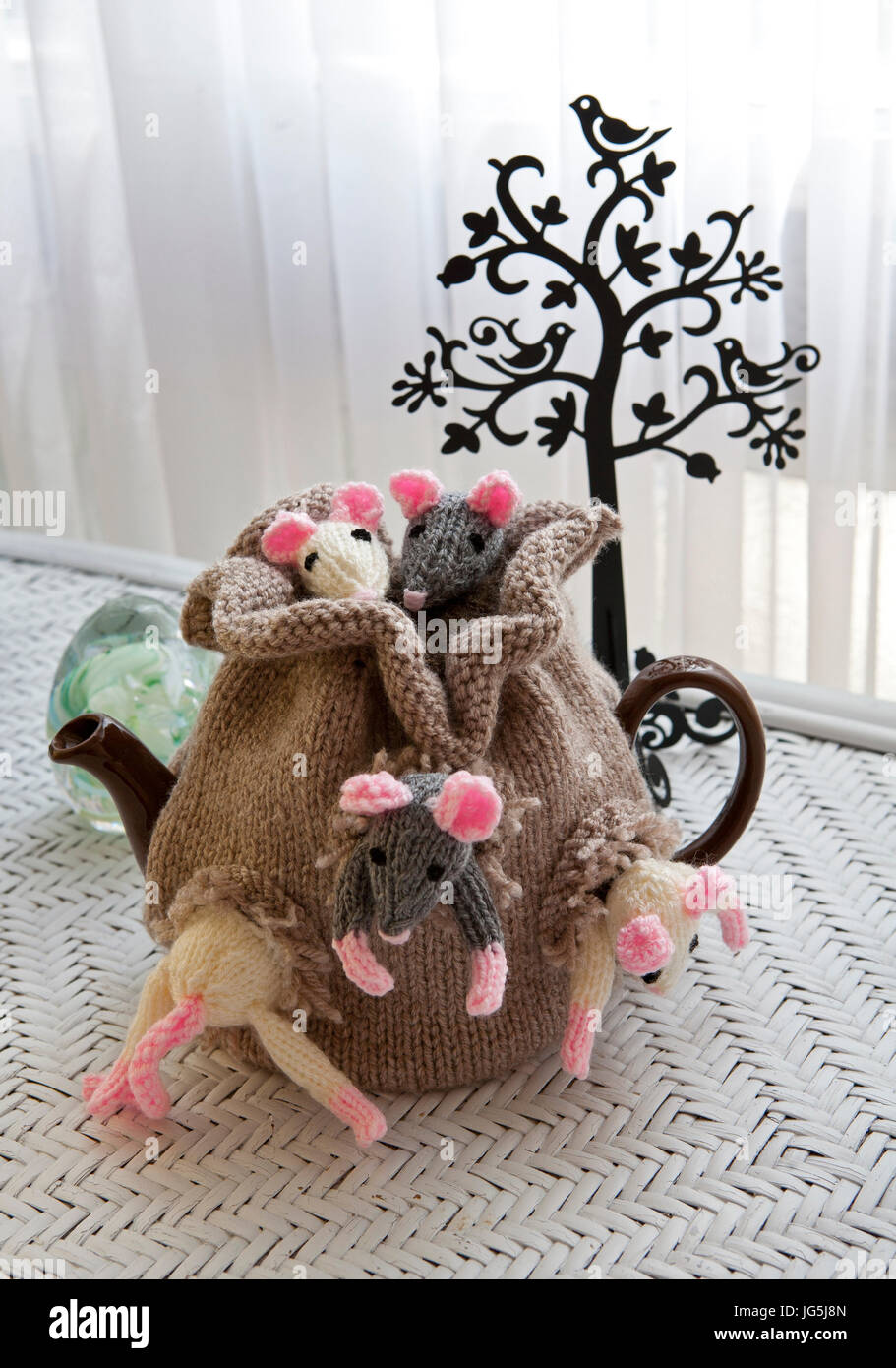 Handknitted tea cosy depicting a sack of mice Stock Photo