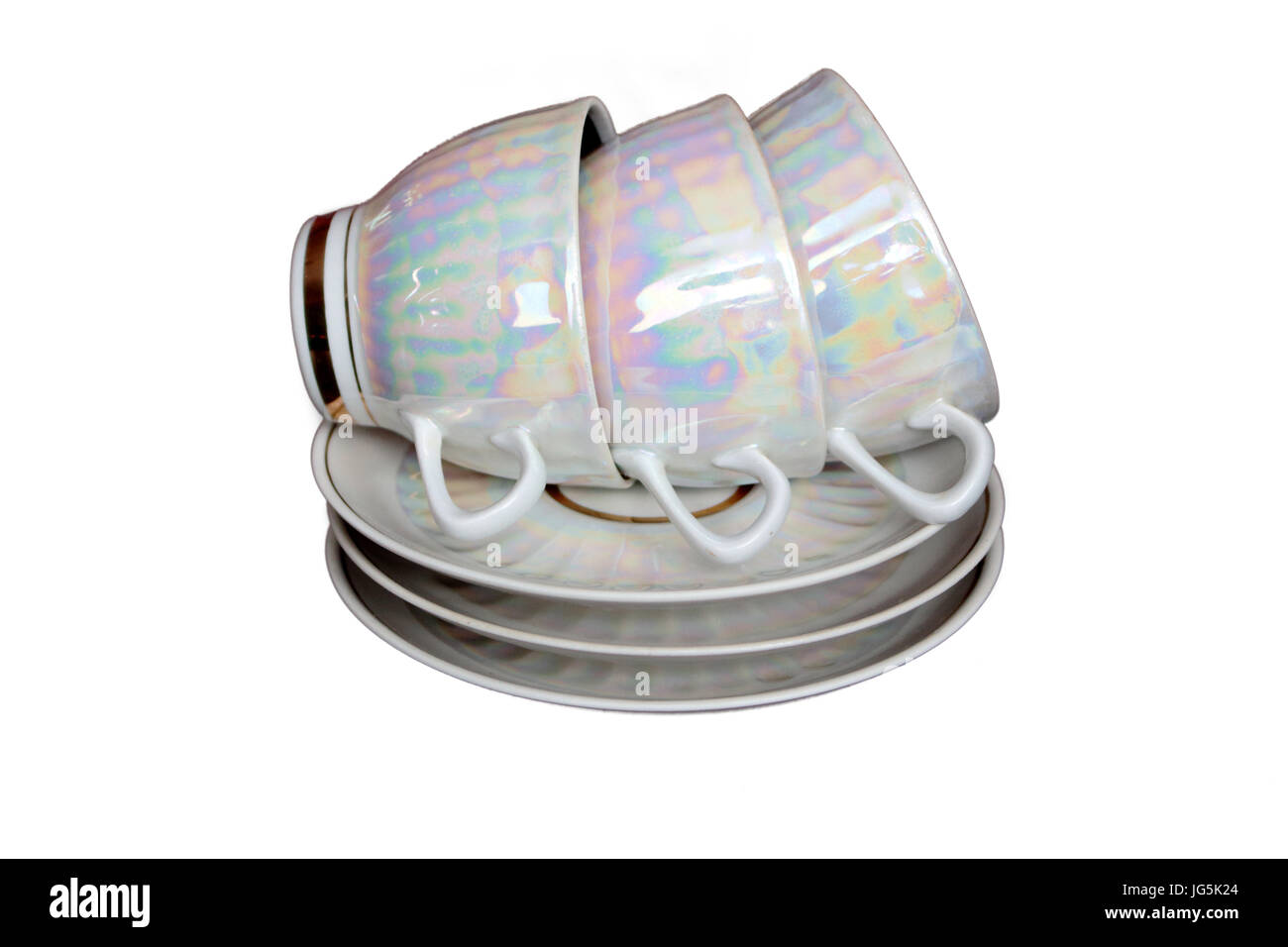 A pile of white iridescent tea cups and saucers Stock Photo Alamy