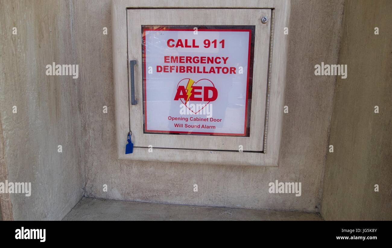 Emergency defibrillator cabinet in cement wall Stock Photo