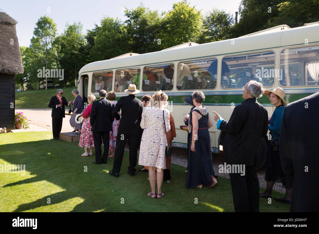 Opera goers at Garsington opera board the bus to see the gardens; Garsington opera, Wormsley Park, Buckinghamshire UK Stock Photo