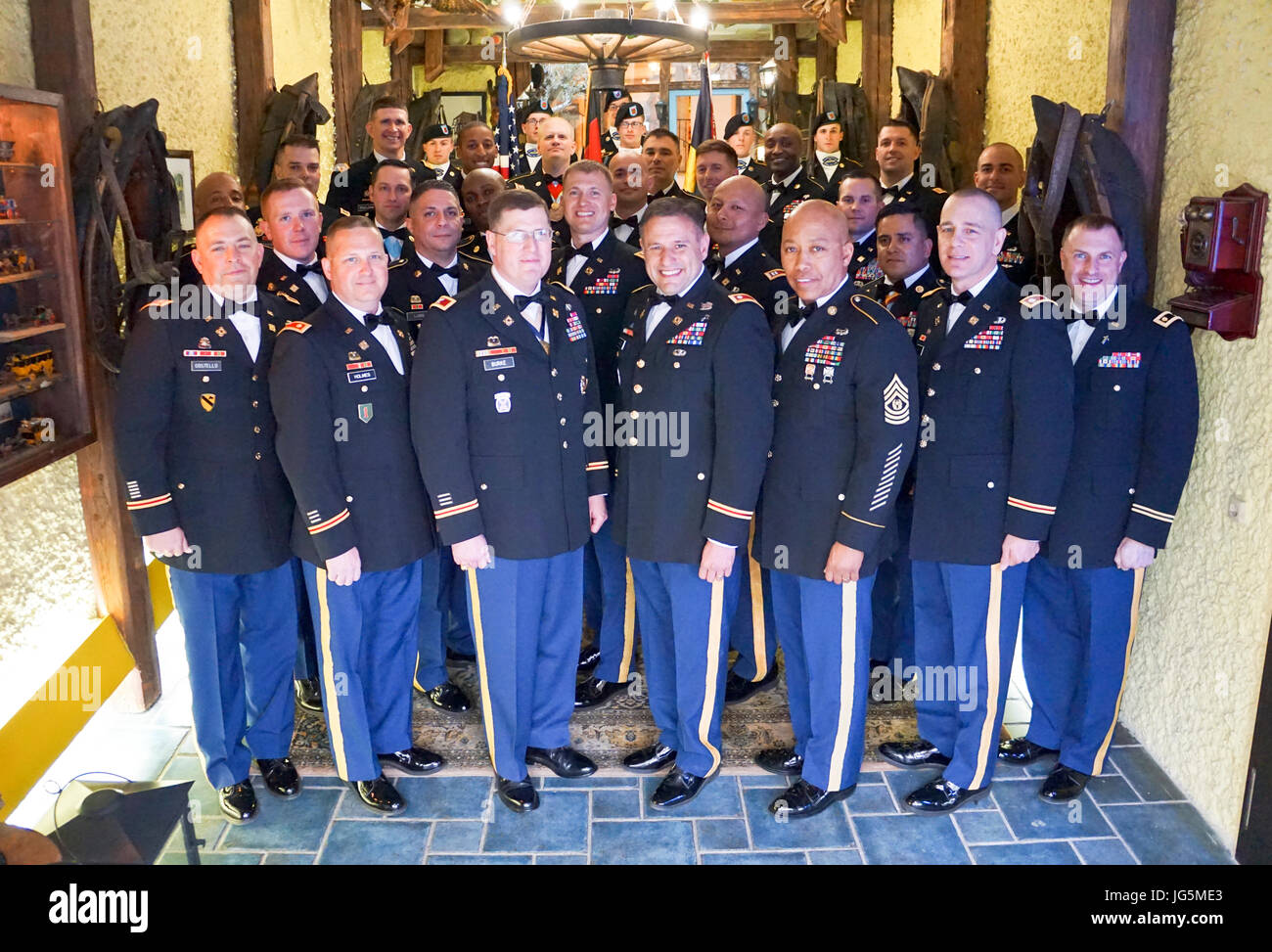 The Joint Multinational Readiness Center's Adler Observer, Coach/Trainer Team attend their annual Dining In held in Velburg, Germany April 2. Lt. Col. Adrian Gamez, Adler Team commander and senior OC/T stands center. The Adler OCT Team teach and mentor leaders and staffs of Brigade Support Battalions, Combat Sustainment Support Battalions and multinational partners preparing them to provide logistic support in austere environments during the conduct of Unified Land Operations. (U.S. Army photo by Sgt. Karen Sampson) Stock Photo