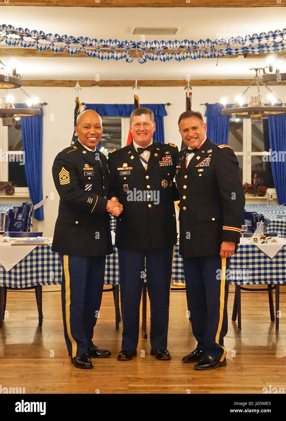 The Joint Multinational Readiness Center's Adler Observer, Coach/Trainer Team attend their annual Dining In held in Velburg, Germany April 2. Lt. Col. Adrian Gamez, Adler Team commander and senior OC/T (right) is pictured with his command team. The Adler OCT Team teach and mentor leaders and staffs of Brigade Support Battalions, Combat Sustainment Support Battalions and multinational partners preparing them to provide logistic support in austere environments during the conduct of Unified Land Operations. (U.S. Army photo by Sgt. Karen Sampson) Stock Photo