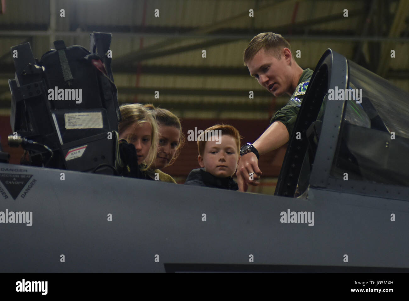 A 492nd Fighter Squadron pilot shows students from Wilds Lodge School the inside of an F-15E Strike Eagle cockpit during a field trip to Royal Air Force Lakenheath, England, June 28. The students had the chance to view a Strike Eagle up close and ask questions on the capabilities of the aircraft. (U.S. Air Force photo/Airman 1st Class Eli Chevalier) Stock Photo