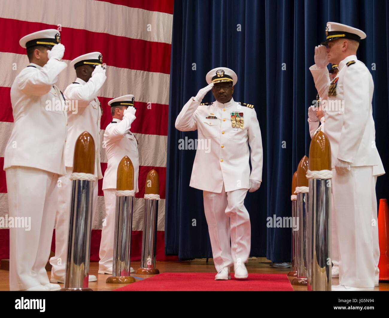 170630-N-KH214-024 OAK HARBOR, Wash. (June 30, 2017) Cmdr. Rodney Moss salutes the sideboys at the Center for Naval Aviation Technical Training Unit (CNATTU) Whidbey Island change of command ceremony held at Naval Air Station Whidbey Island. Cmdr. Kelly Bishop relieved Moss as commanding officer of CNATTU. (U.S. Navy photo by Mass Communication Specialist 2nd Class Scott Wood/Released) Stock Photo
