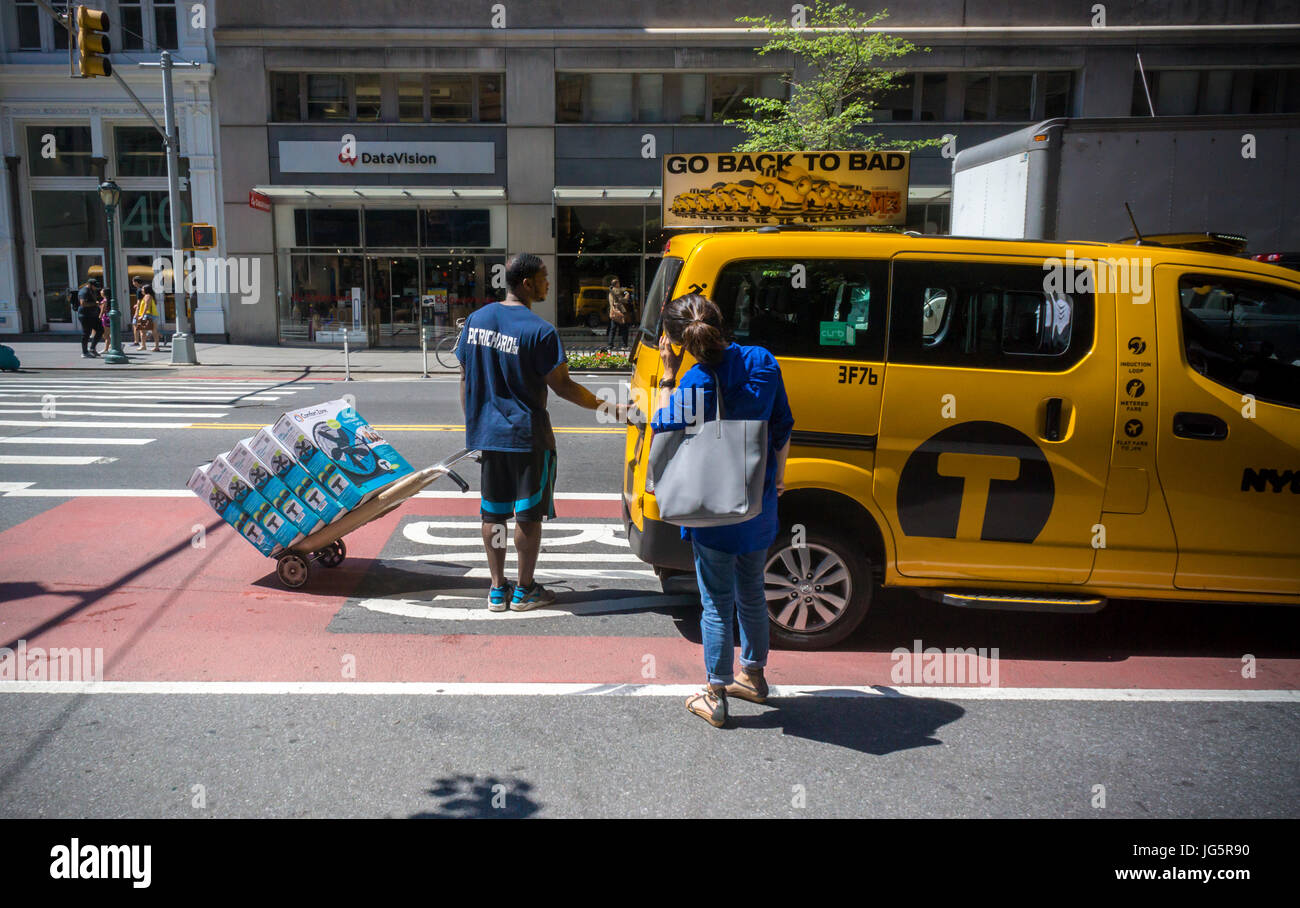 A P.C. Richards appliance store employee assists a customer in loading
