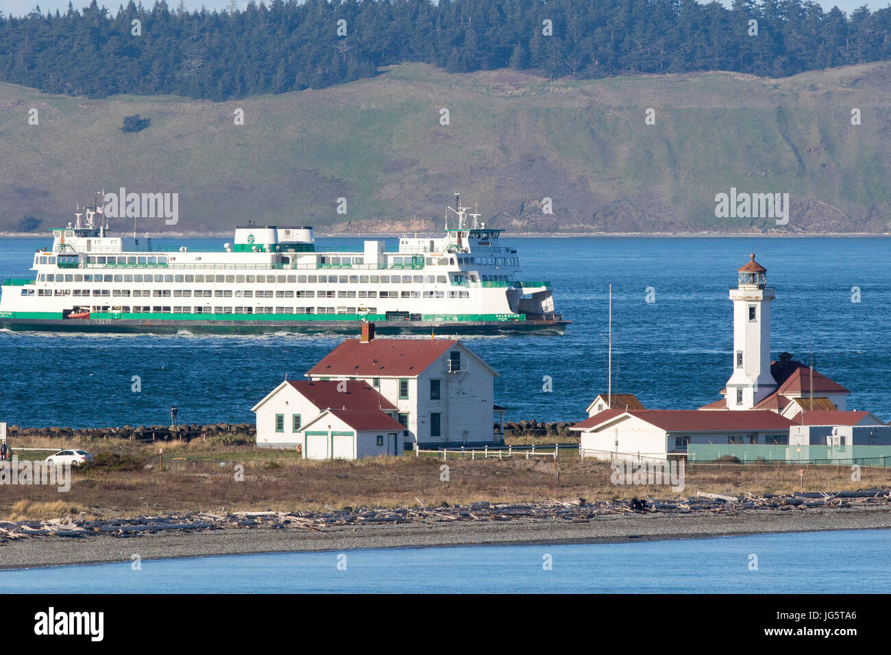 Ferry passes by Point Wilson lighthouse, light house, in Port Townsend, Washington. Stock Photo