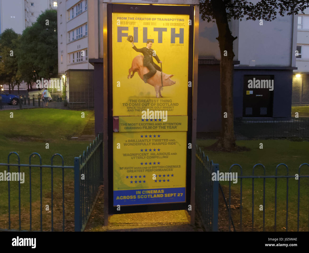 advert for the film filth that covers a public telephone box based on book by  Irvine Welsh Trainspotting author stars James McAvoy Stock Photo