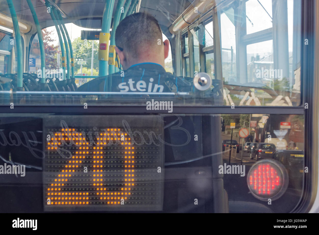 football top with stein name boy sitting on a bus with its number taking the place of the football strip number  red light concept shot Stock Photo