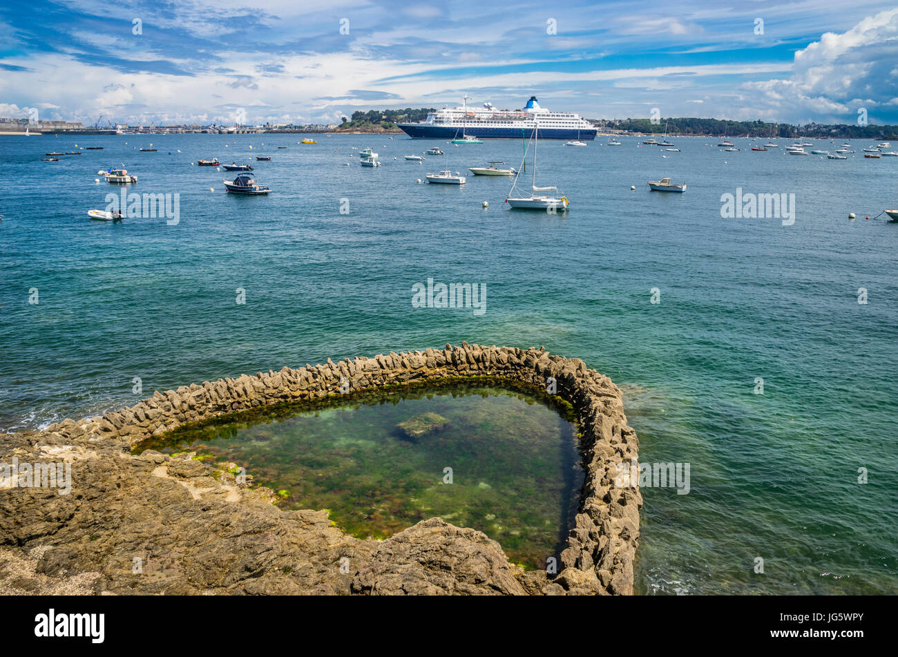 France, Brittany, Dinard, tidal rock pool on the banks of Rance River waterfront at the Promenade du Clair de Lune Stock Photo