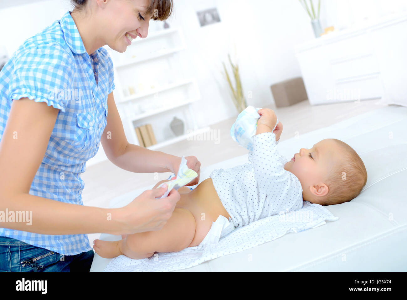 mother changing baby nappy Stock Photo Alamy