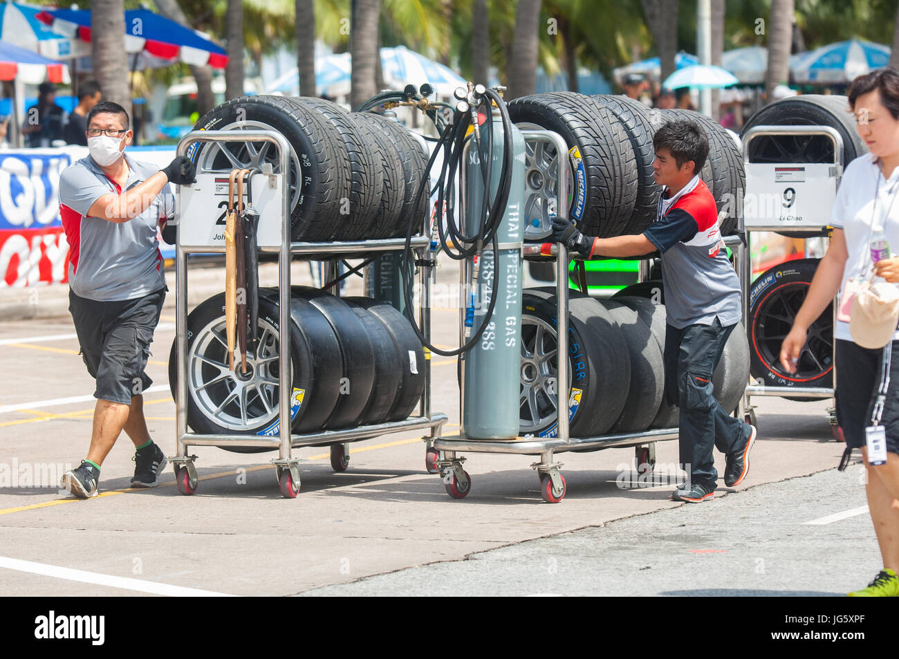 Tyre racks for the participants of Porsche Carrera Cup Asia being moved to the pit lane at Bang Saen Street Circuit in Bang Saen, Chonburi, Thailand. Stock Photo