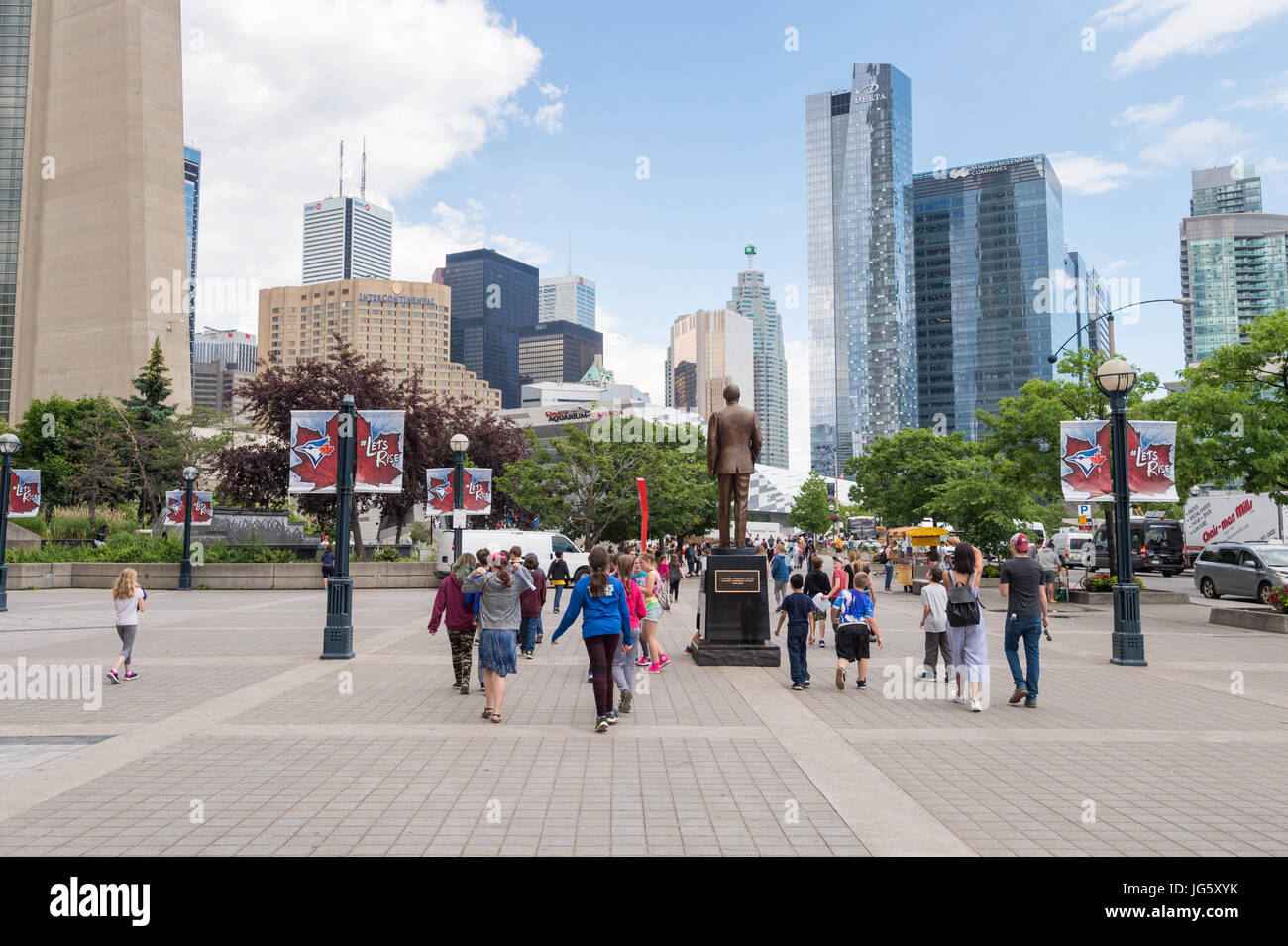 Toronto, Canada - 26 June 2017: People walking on Bremner Blvd in Downtown Toronto, with Toronto Cityscape in the background Stock Photo