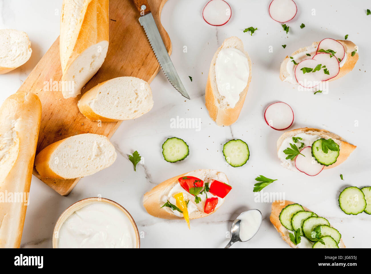 Healthy food. Spring, summer snacks. Sandwiches toast with homemade cream cheese and fresh vegetables - radish, cucumber, tomatoes, onion, pepper. On Stock Photo