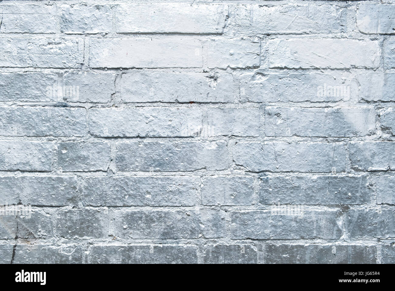 brick stone wall  painted in silver - graffiti background Stock Photo