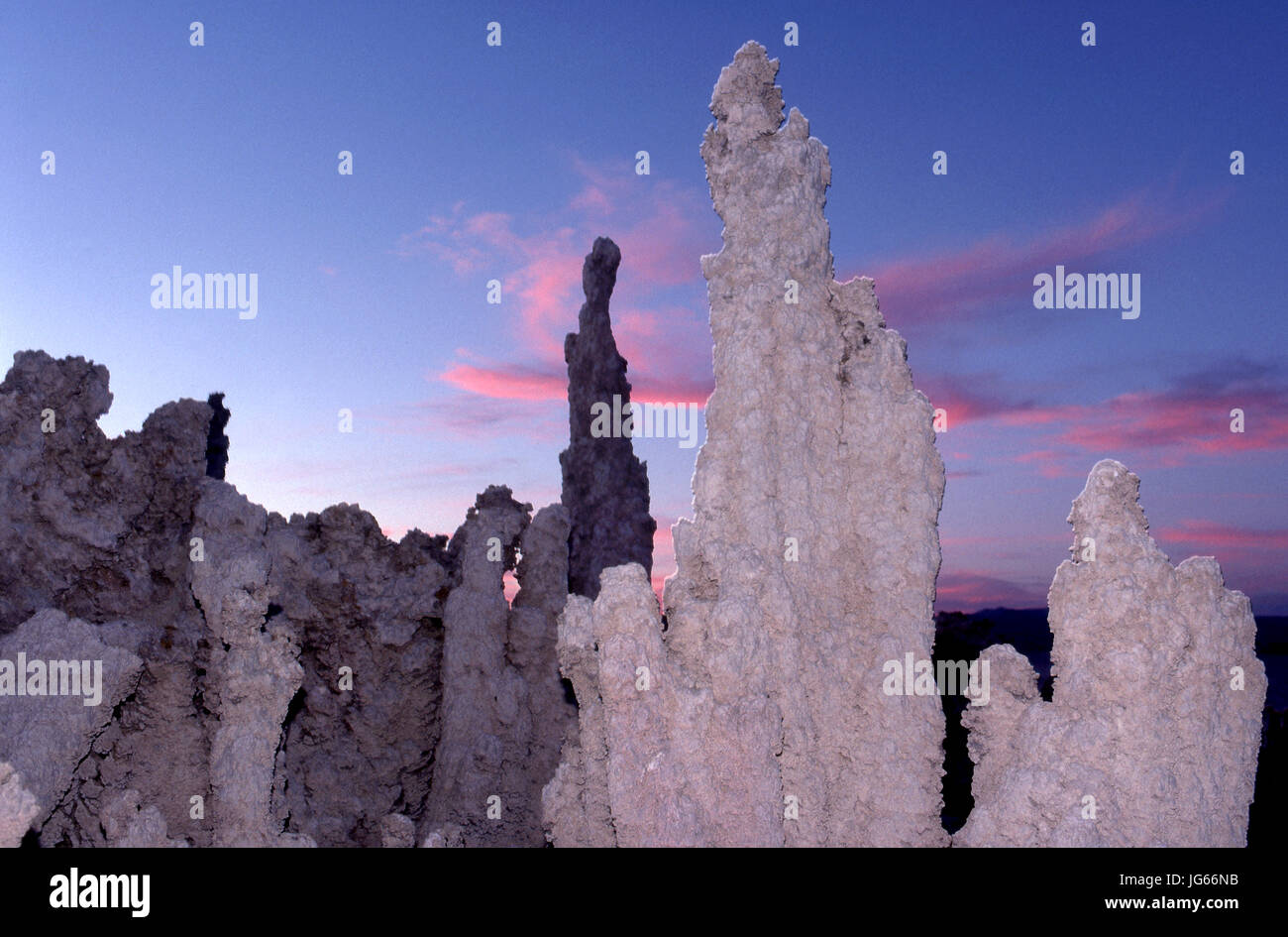 Unusual tufa formations look more surreal with added artificial  lighting at sunset at  Mono Lake in California, Stock Photo