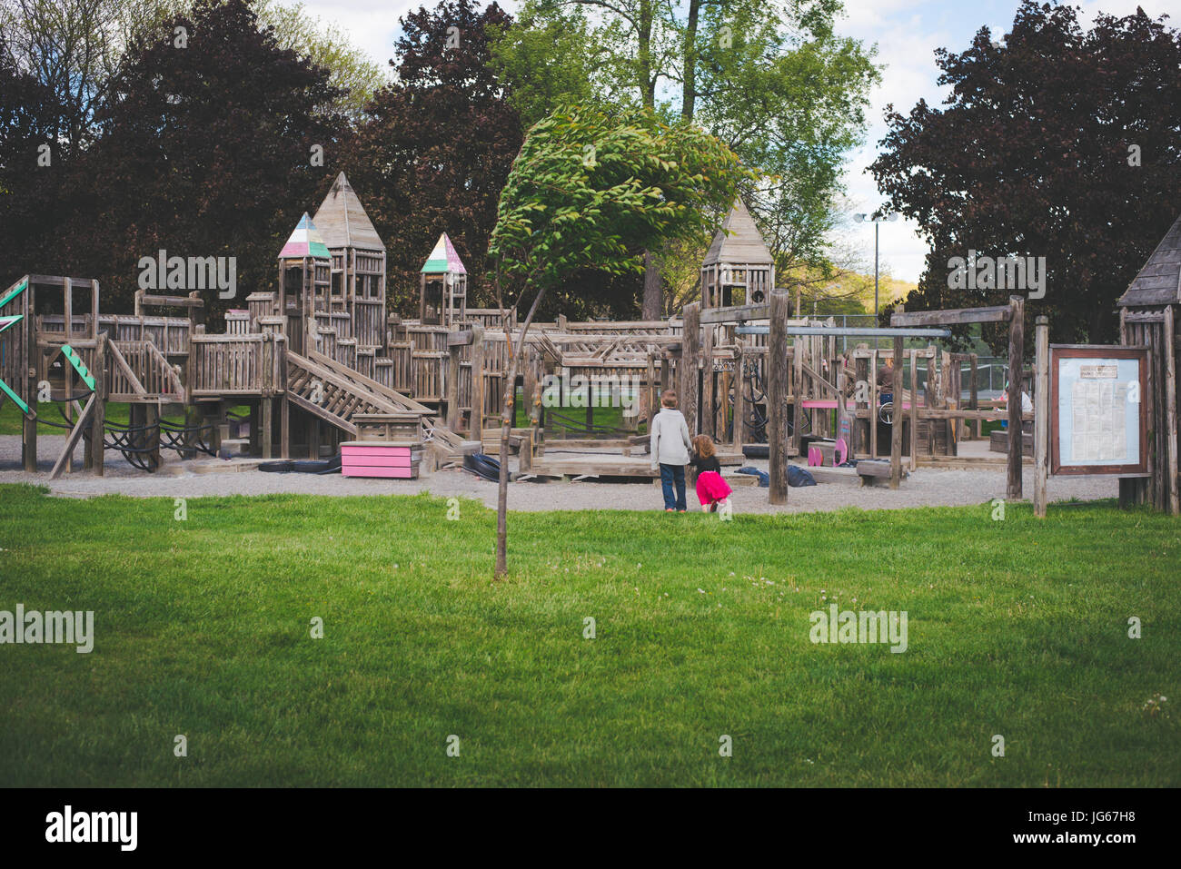 Siblings walk to a playground. Stock Photo