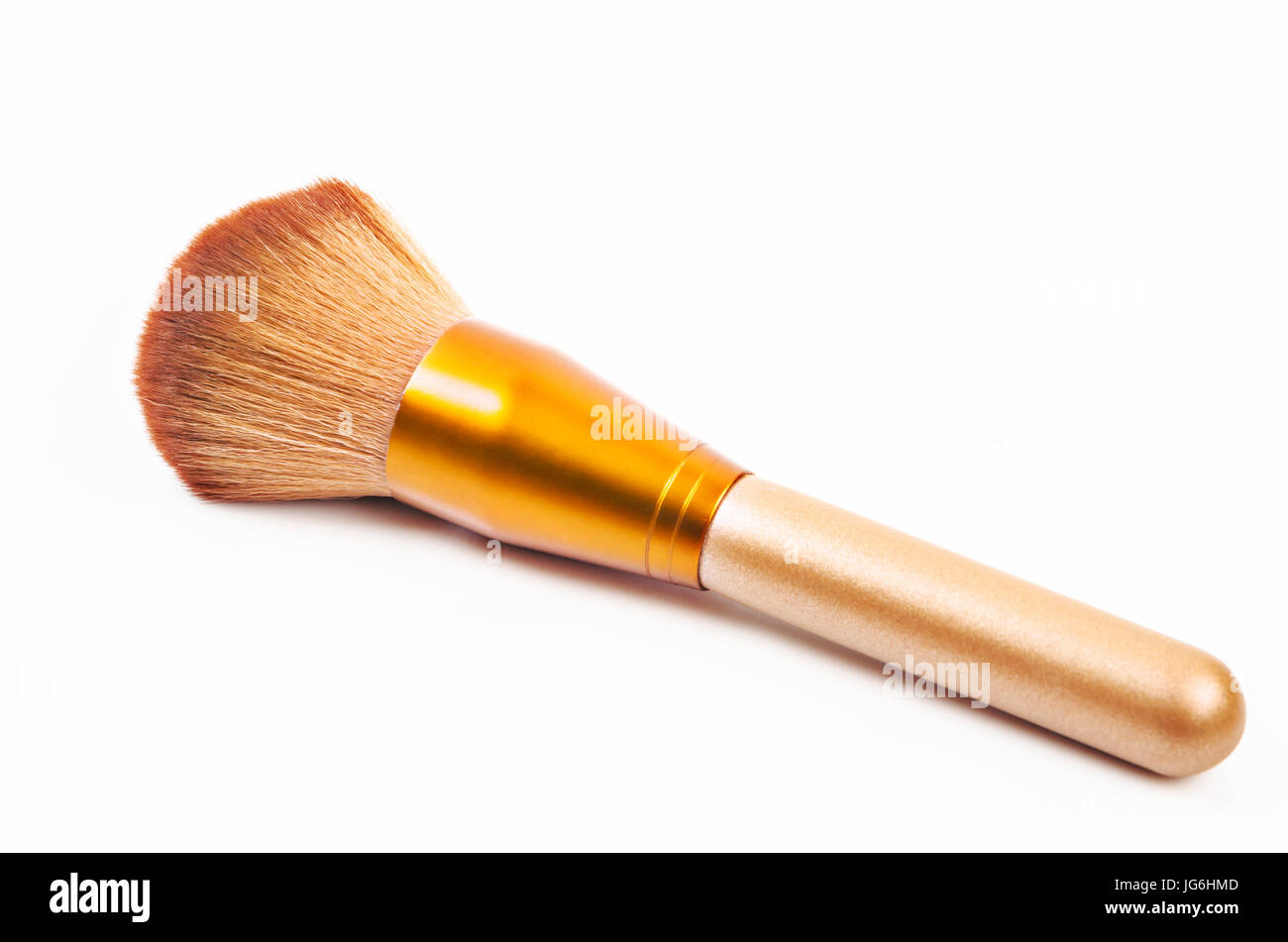 Makeup gold brush powder Blusher on white background. Stock Photo