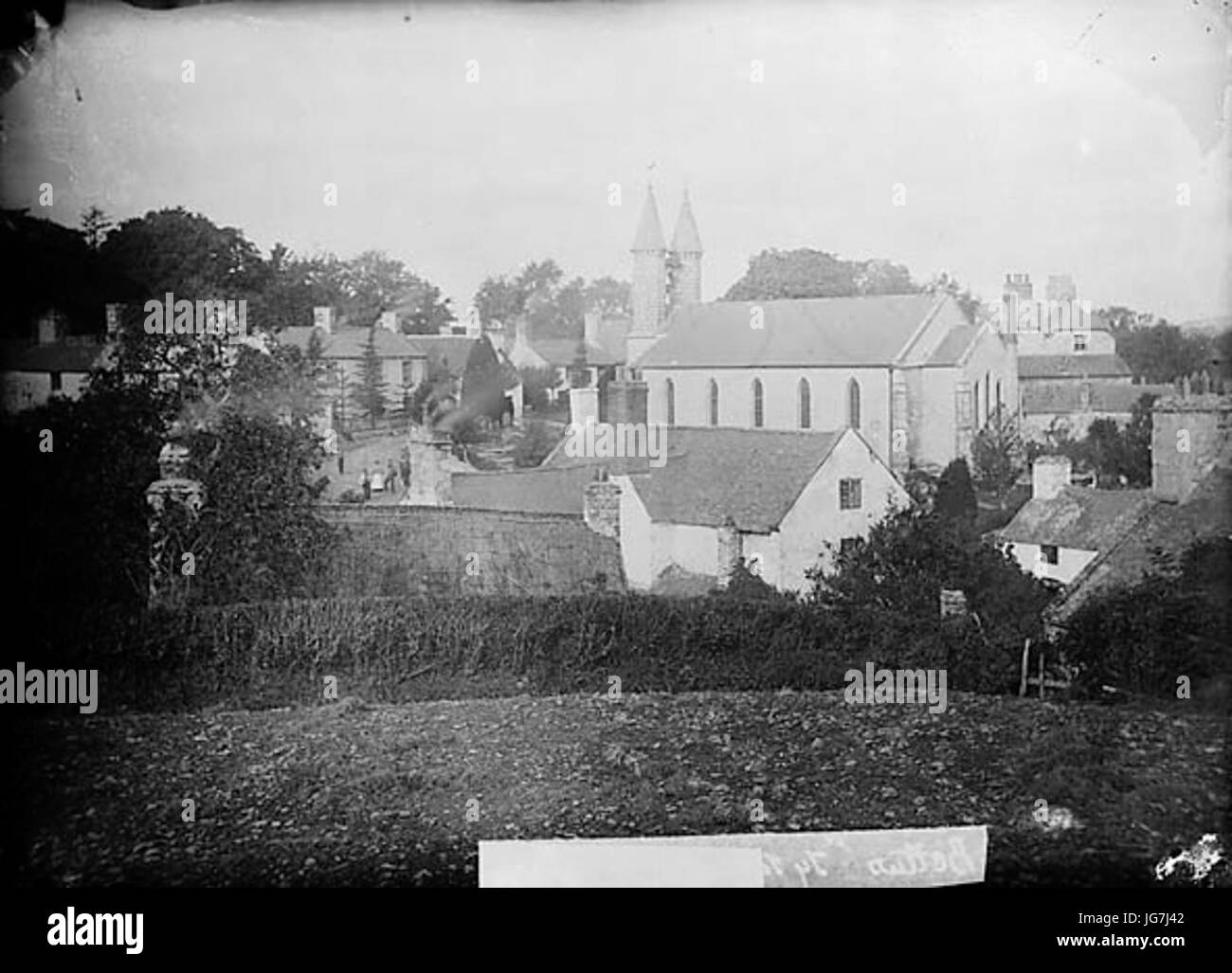 Thatched house and the church Betws-yn-Rhos NLW3362963 Stock Photo