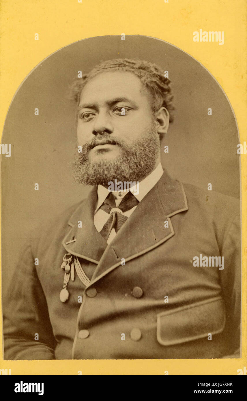 Uelingatoni Ngū, wearing jacket, shirt, neck tie with a ring and chain ornament attached to his jacket lapel Stock Photo
